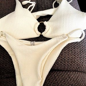 Pretty, ring-linked Bikini. White, textured, double knit material.